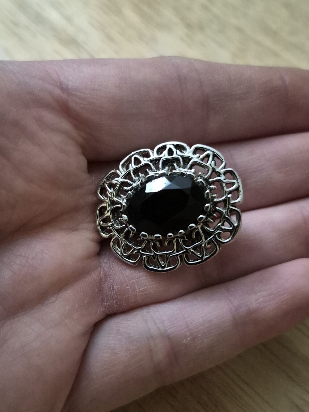 Silver Tone Filigree Frame Brooch With Black Faceted Center